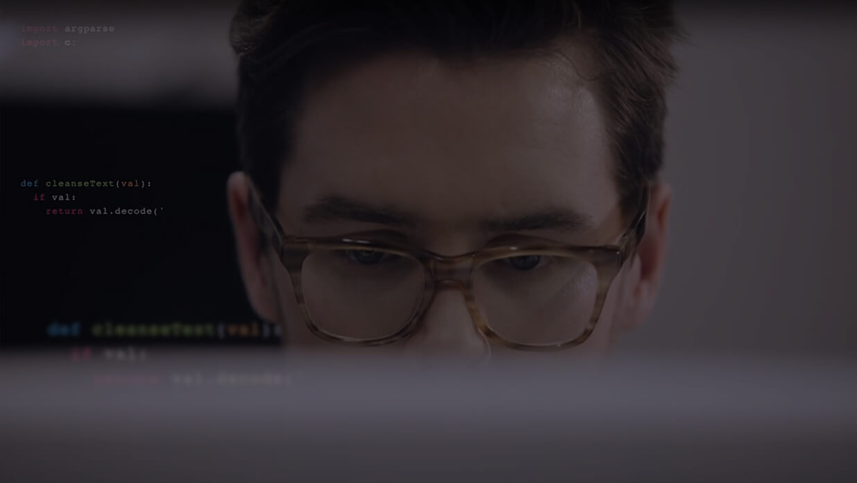 Business professional looking at secure data off monitor screen
